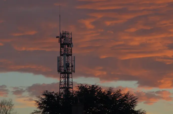 a tower with a cell phone on top of it