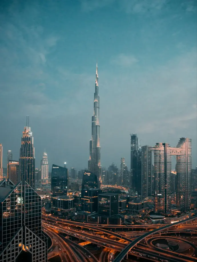 a view of a city at night from the top of a skyscraper
