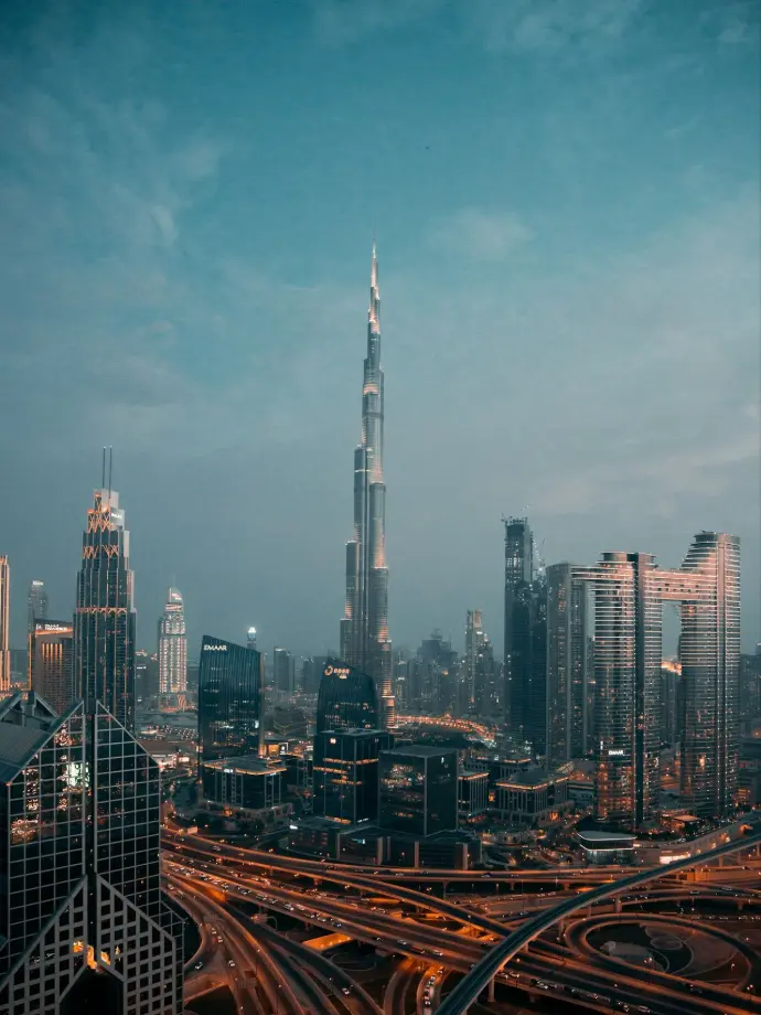 a view of a city at night from the top of a skyscraper
